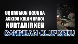 Uçurumun ucunda askıda kalan aracı kurtarırken canlarından oluyorlardı