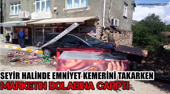 Seyir halinde emniyet kemerini takarken marketin dolabına çarptı