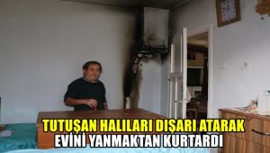 Tutuşan halıları dışarı atarak evini yanmaktan kurtardı